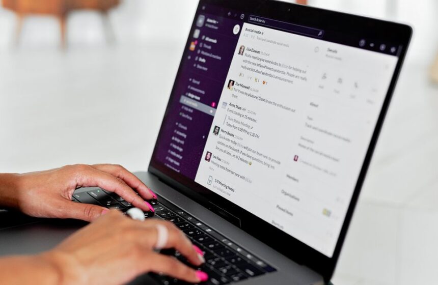 A laptop showing email notifications for a website workflow.