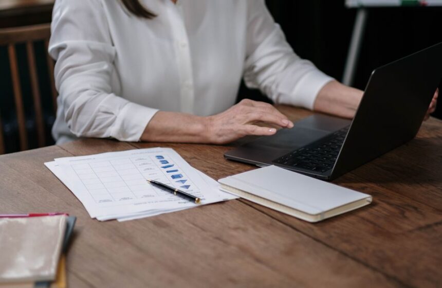 An email list review workspace with a laptop and notes.