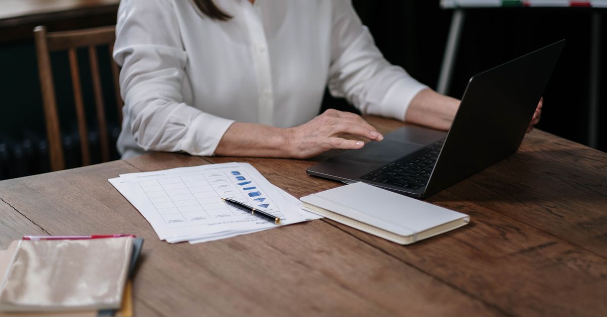 An email list review workspace with a laptop and notes.