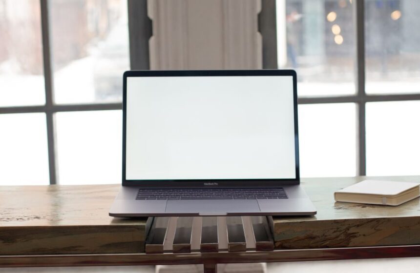 A laptop showing an email dashboard with subscriber groups on screen.