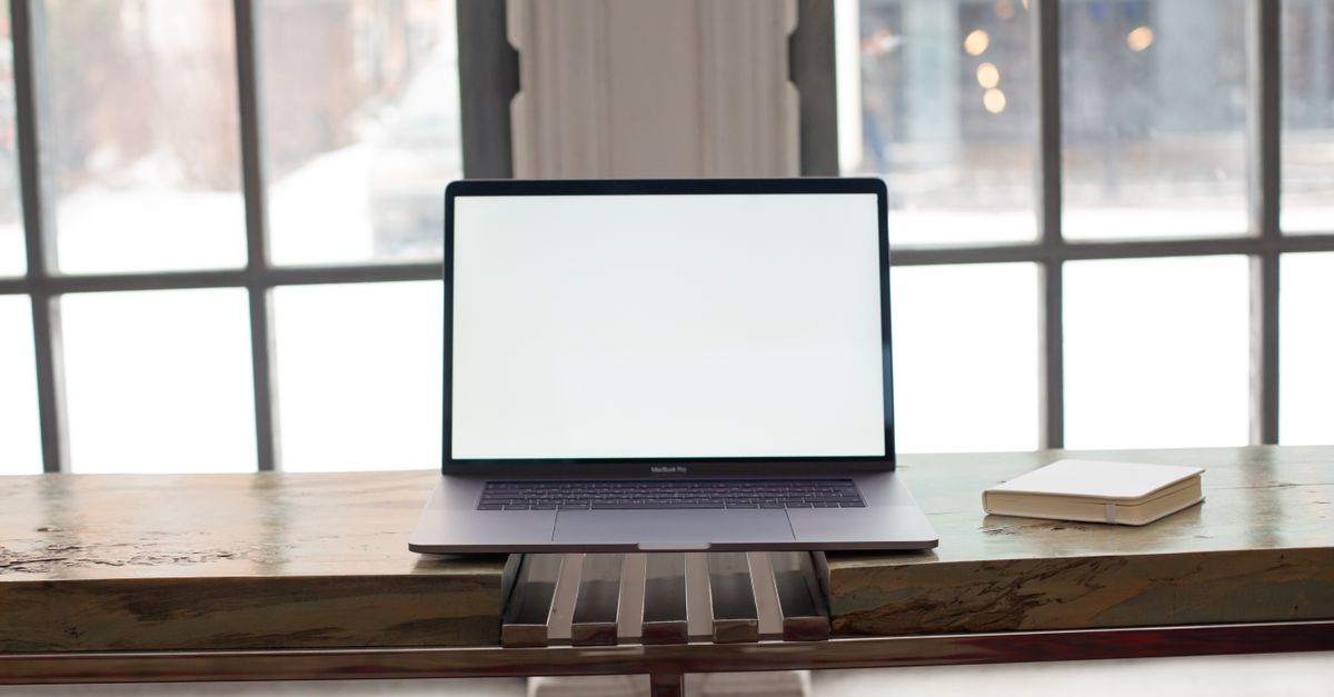A laptop showing an email dashboard with subscriber groups on screen.
